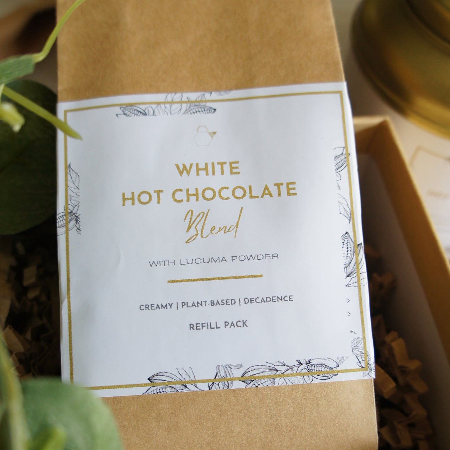 Kraft paper packaging of White Hot Chocolate Blend with decorative elements.