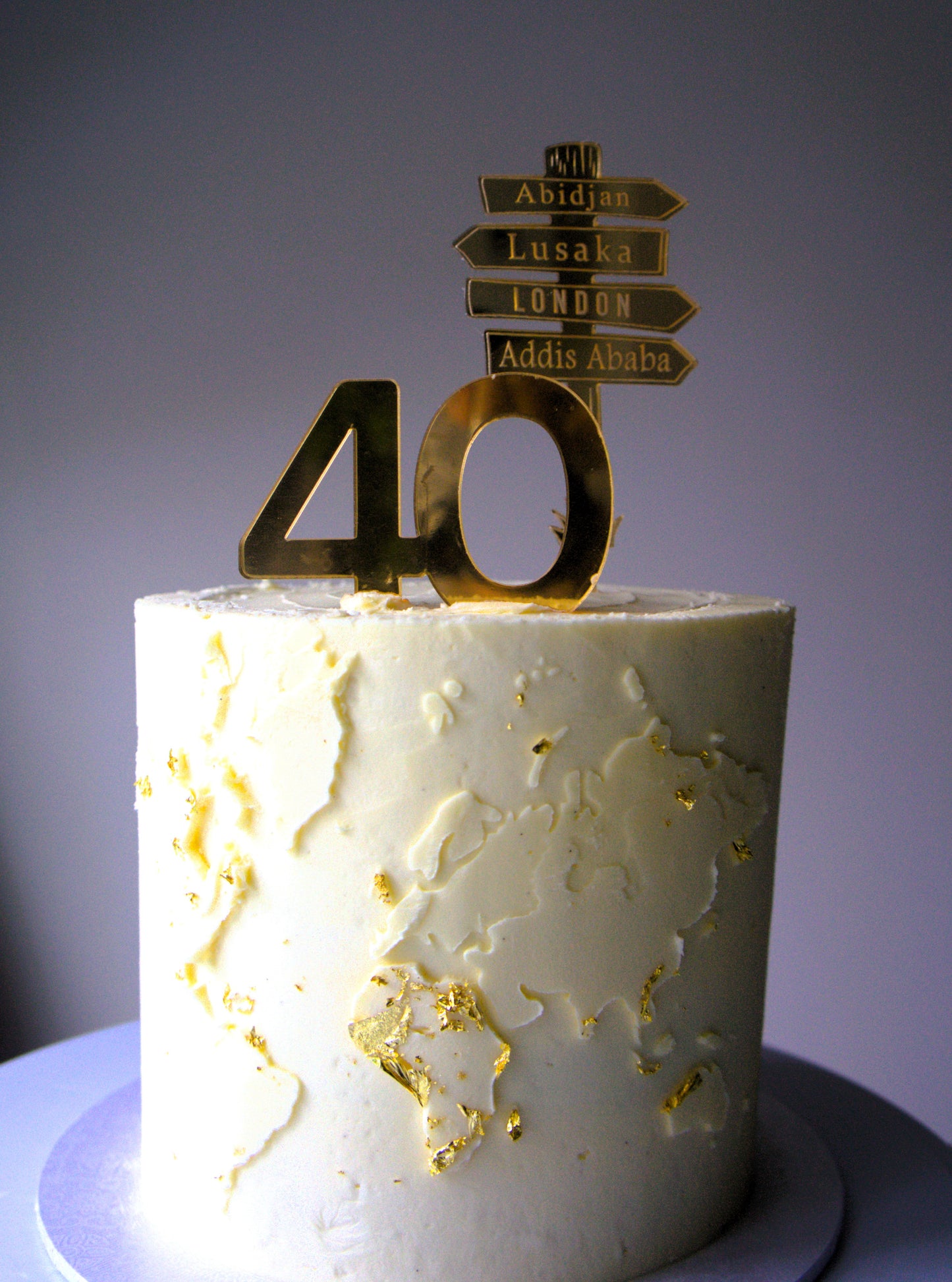 Personalised world map celebration cake with gold milestone topper, dairy-free and nut-free