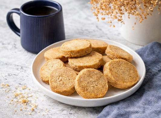 Plate of vegan gluten-free shortbread biscuits served with tea on marble surface
