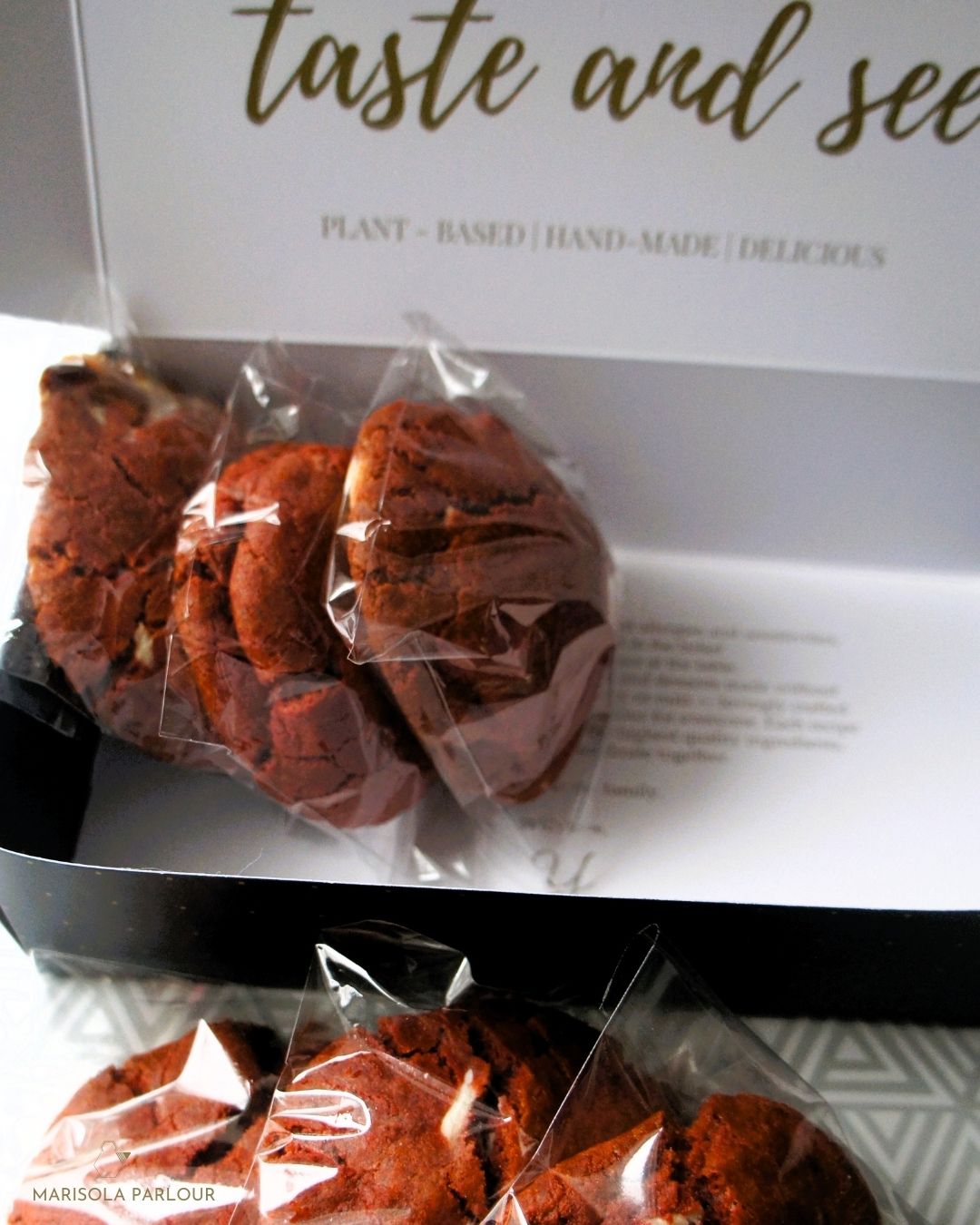 Packaged plant-based cookies with a branded box in the background