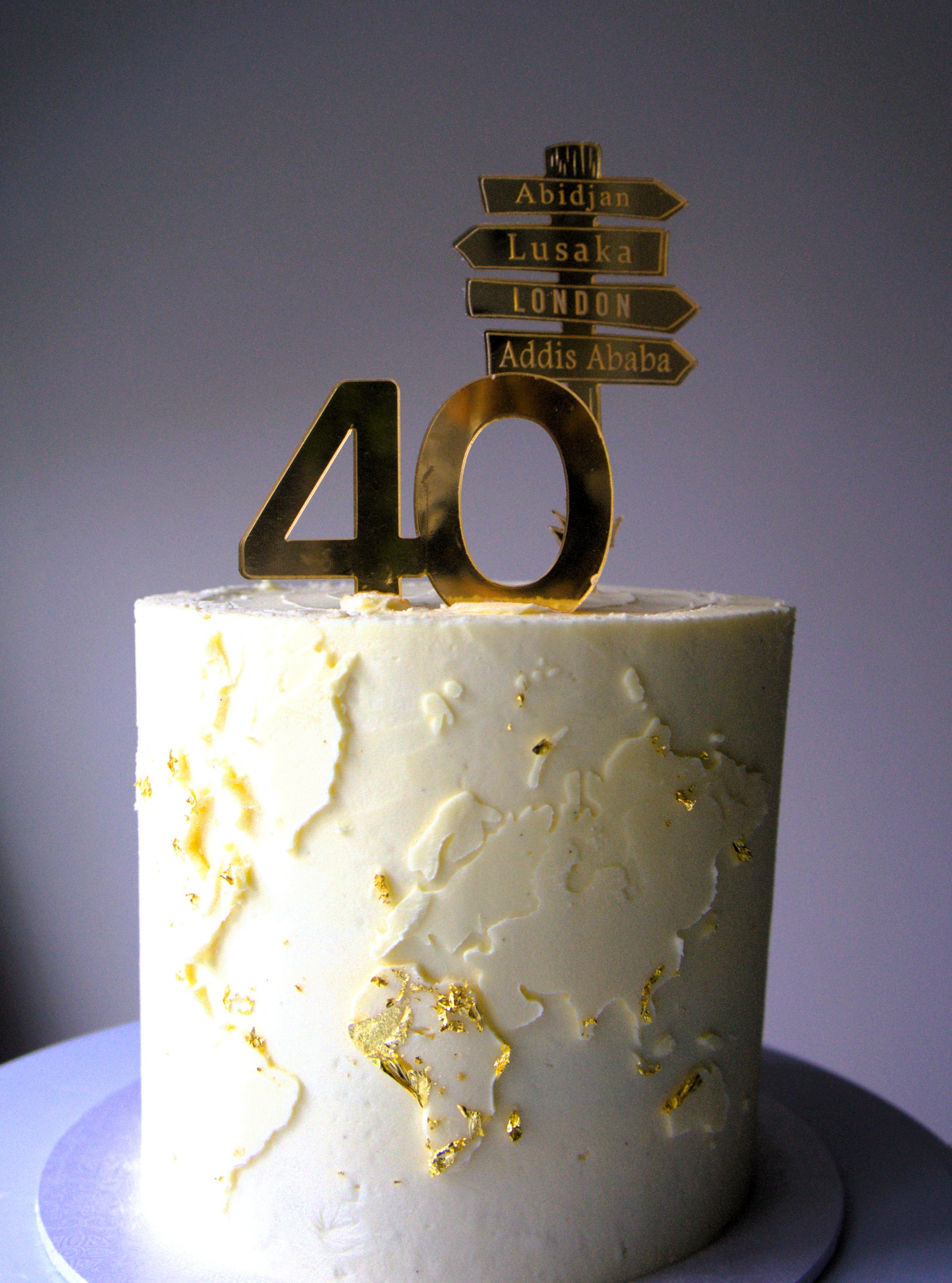 Personalised world map celebration cake with gold milestone topper, dairy-free and nut-free